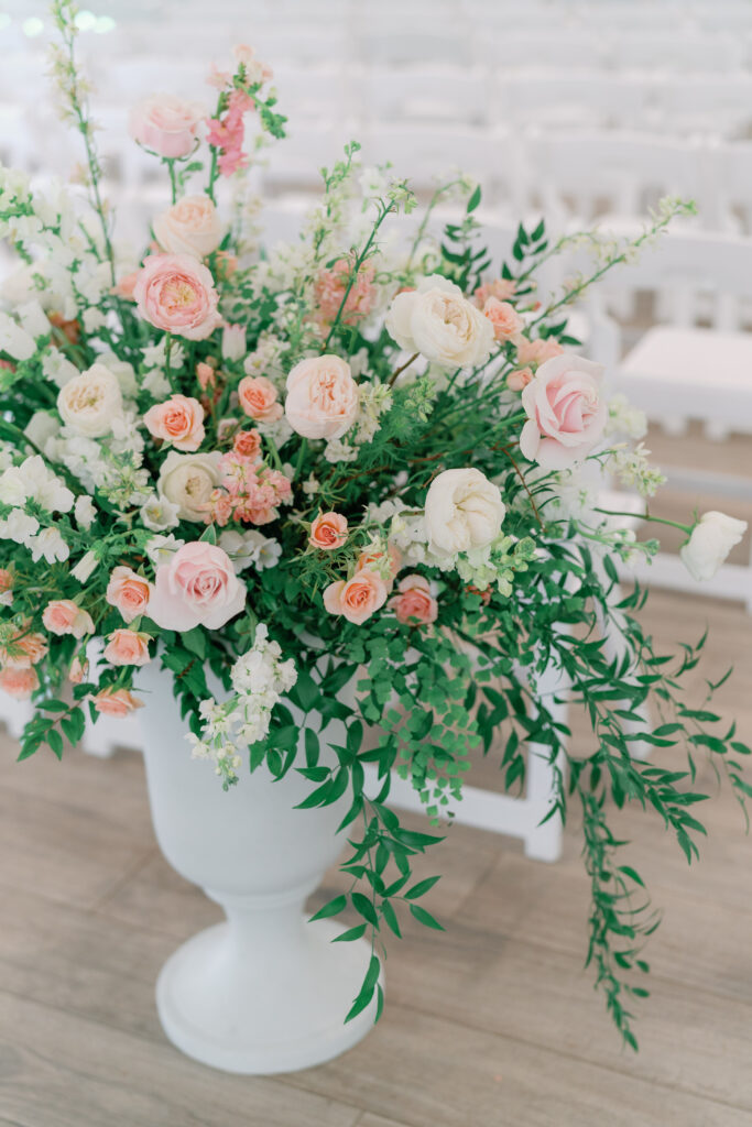 Pedestal flowers at the aisle. 