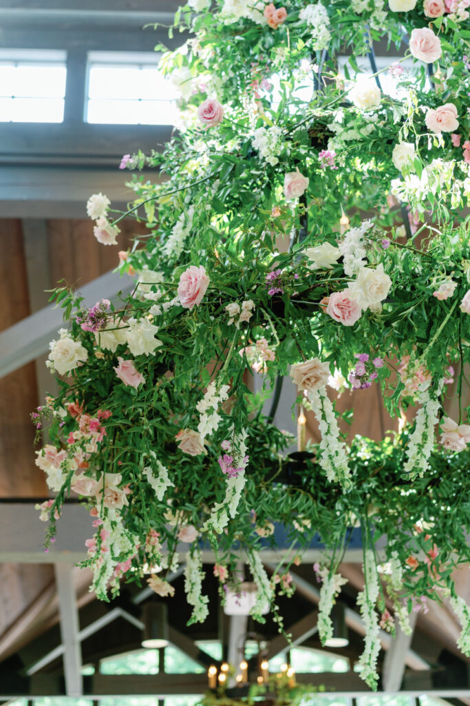 farm at old edwards wedding reception chandelier decorated in flowers. 