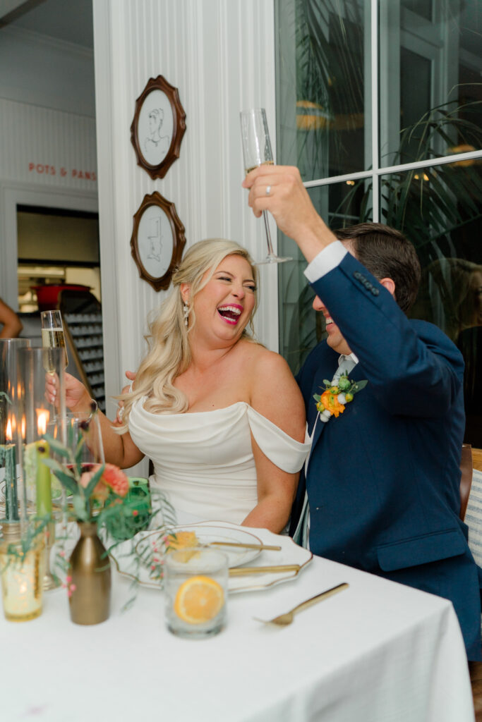 Bride laughs at groom during speeches. 