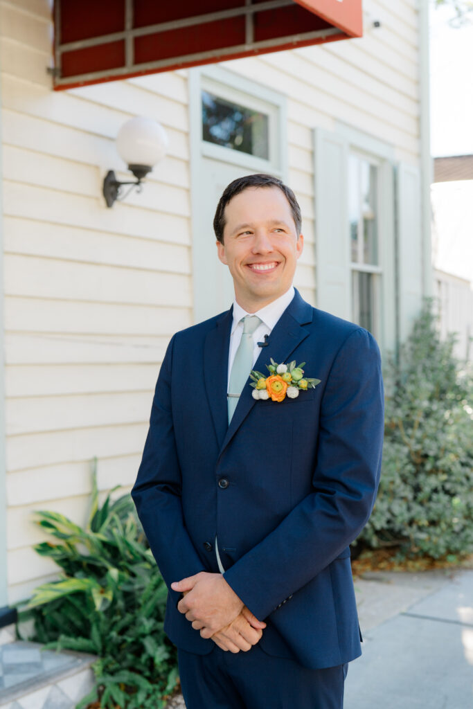 Charleston groom in blue suit with pocket square full of flowers. 