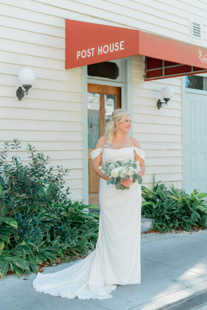 Bride standing in front of the Post House Inn.