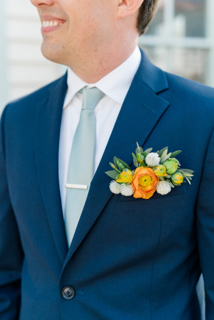Flower pocket square on groom's blue suit
