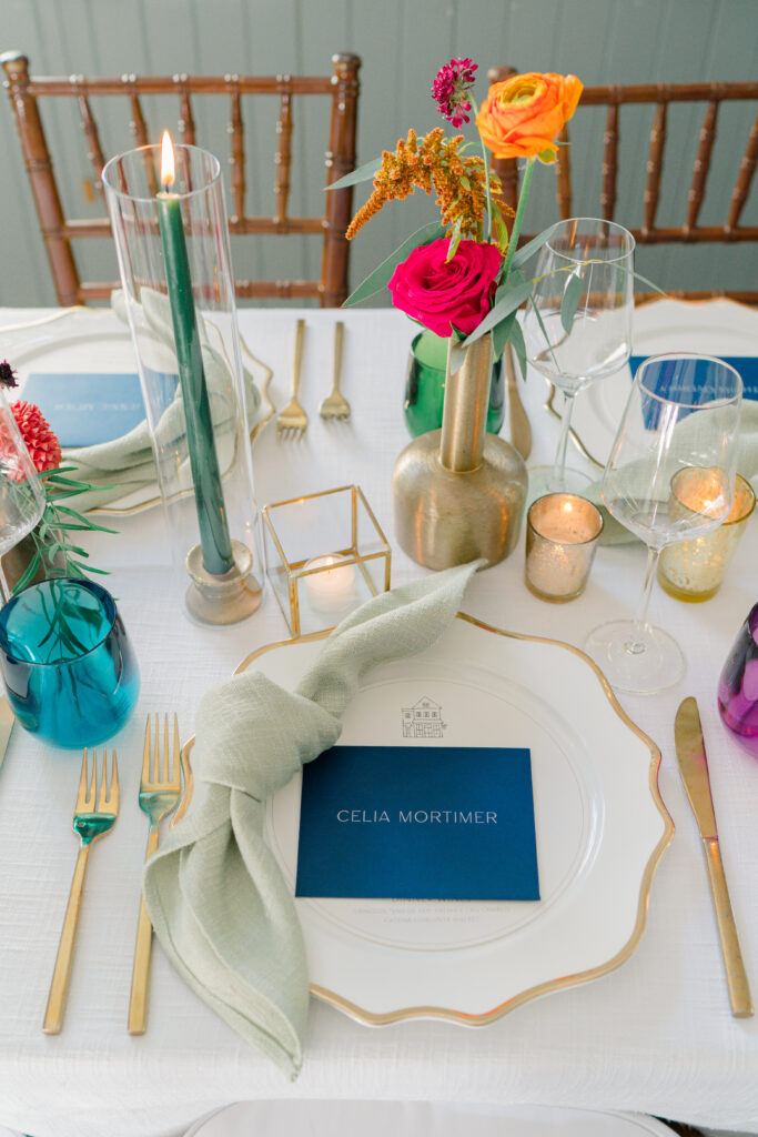 Detailed, color-filled wedding reception dinner place setting. 