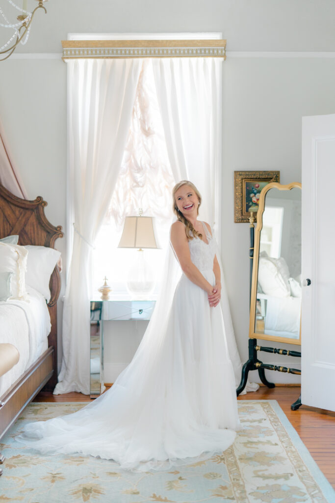 Bride puts on her dress on the morning of wedding. 
