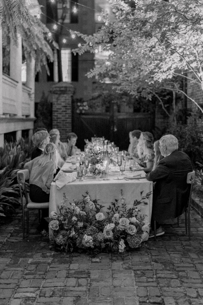 Black and white night photo of candlelit dinner intimate wedding.
