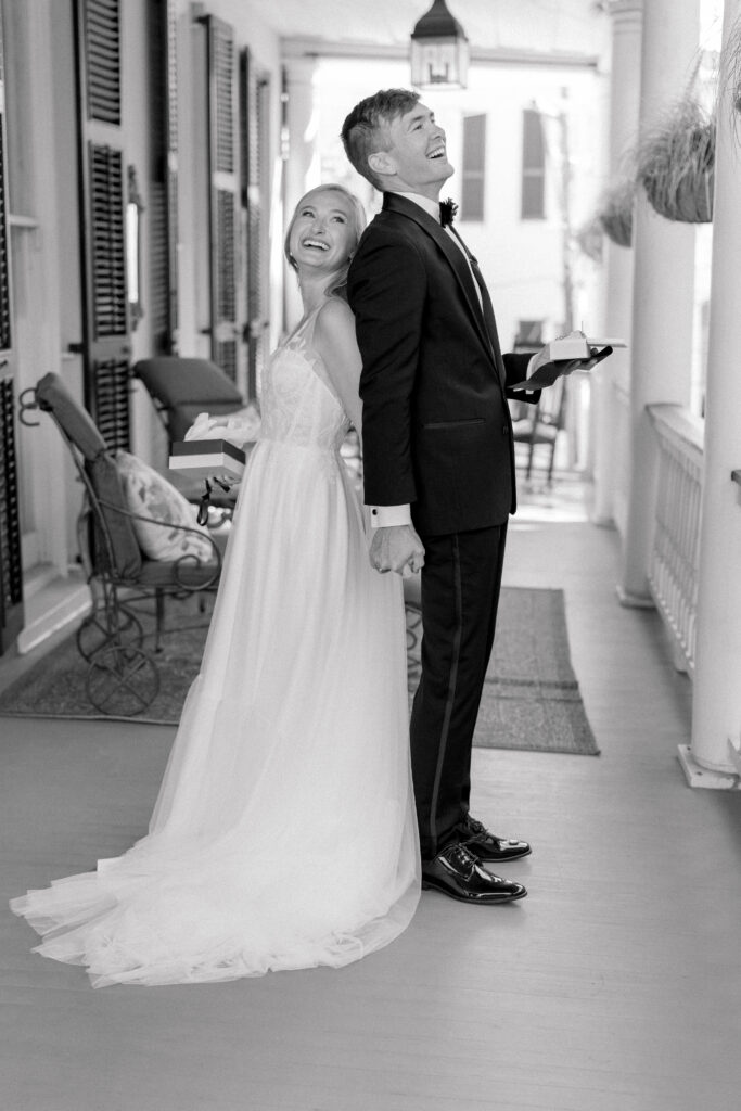 Bride and groom first touch private vow reading. Black and white wedding photo.