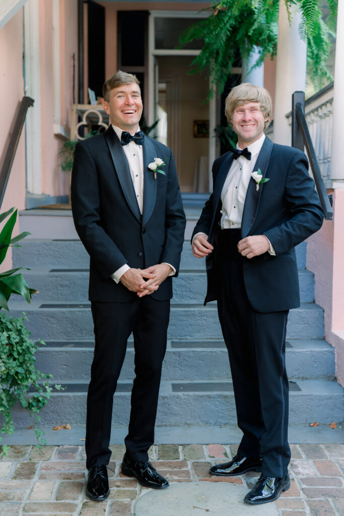 Groom and his brother on wedding day laughing at the camera. 