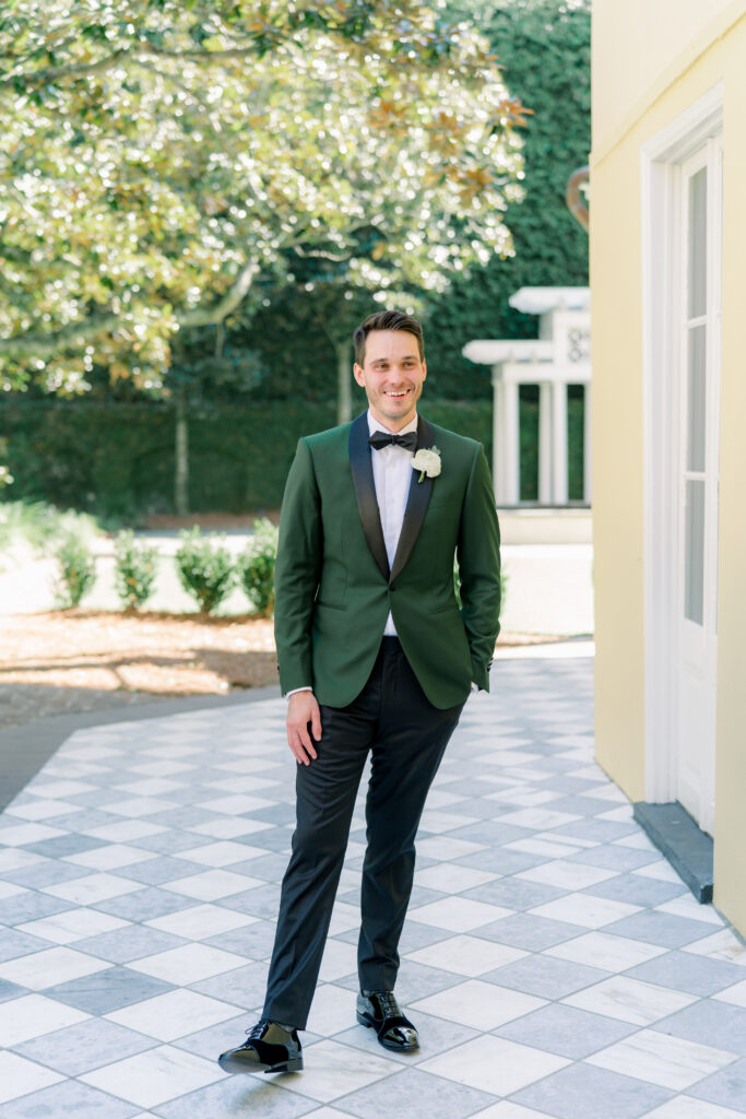 Charleston groom in dark green tuxedo jacket. 