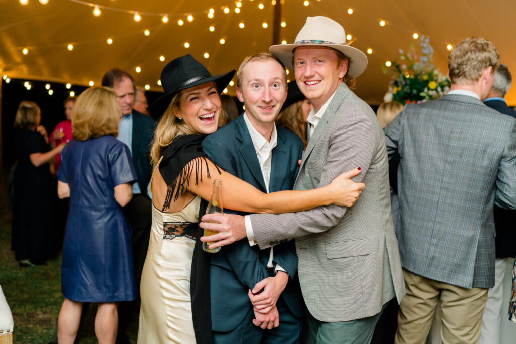 Fun wedding welcome party photo of guests with stetson hats. Destination wedding welcome party in Charleston. 