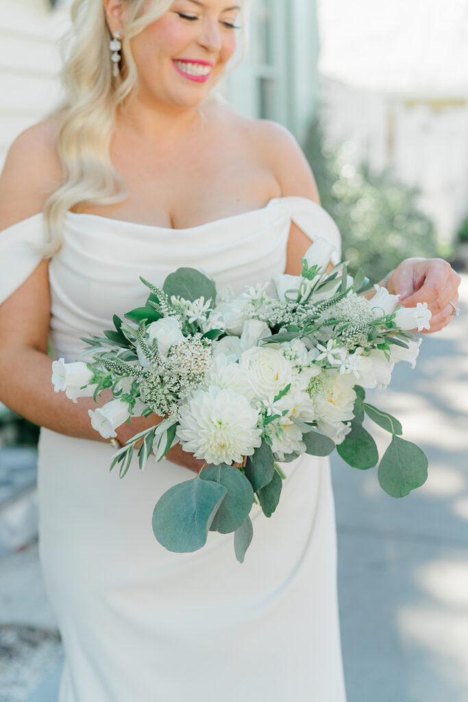 Bride with white and green bouquet. 