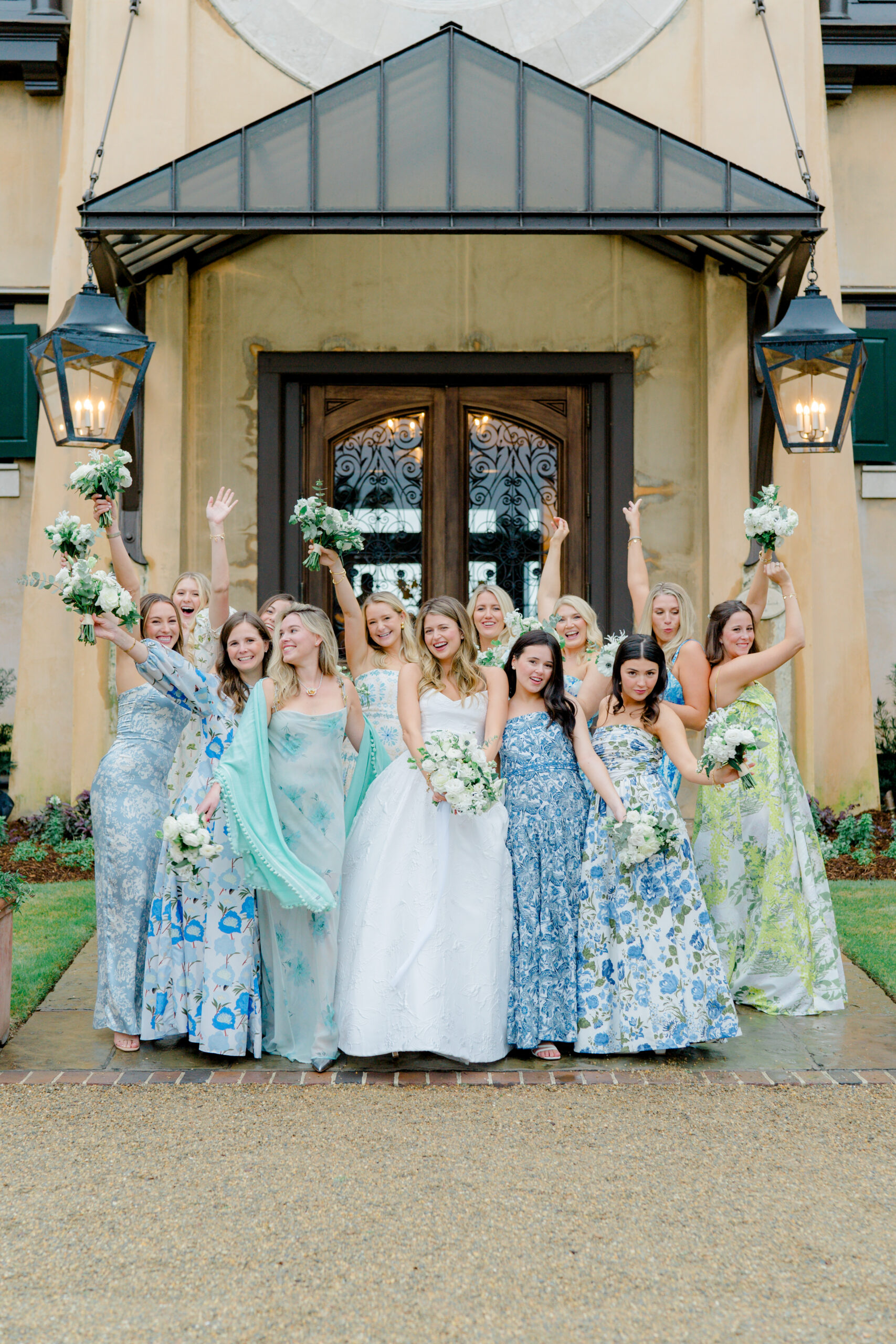 Bride with bridesmaids celebrating with their flowers in the air. 