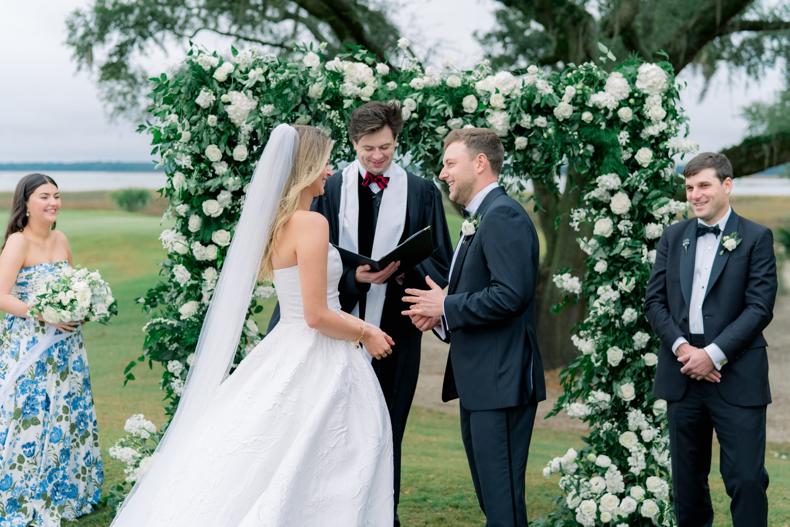 Groom feels wedding ring on his finger for the first time. Outdoor wedding ceremony on Kiawah Island. 