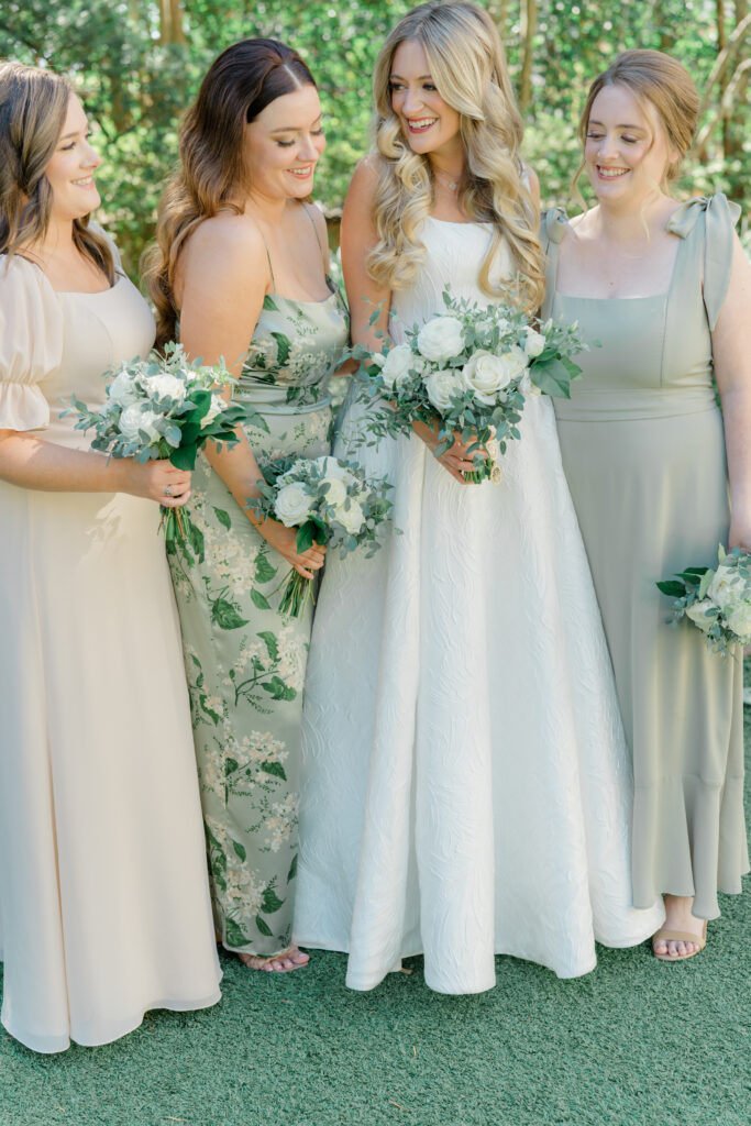 Bride and bridesmaids with white and green flowers. 