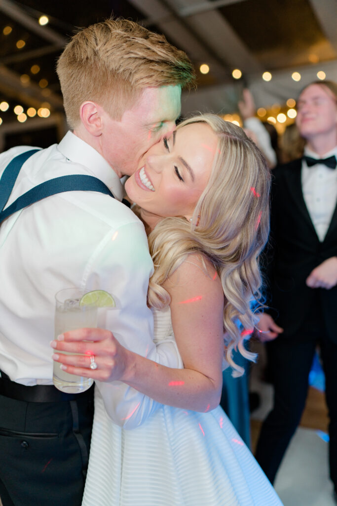Groom kisses bride on the dance floor. Photographers in charleston