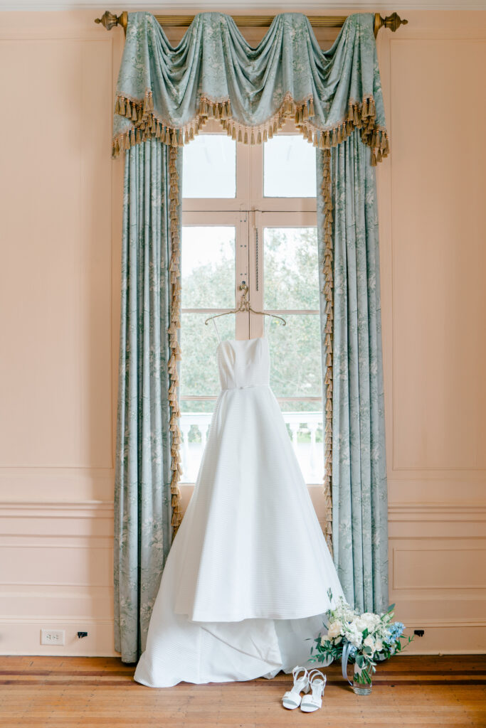 Wedding dress hanging in the pink room at Lowndes Grove