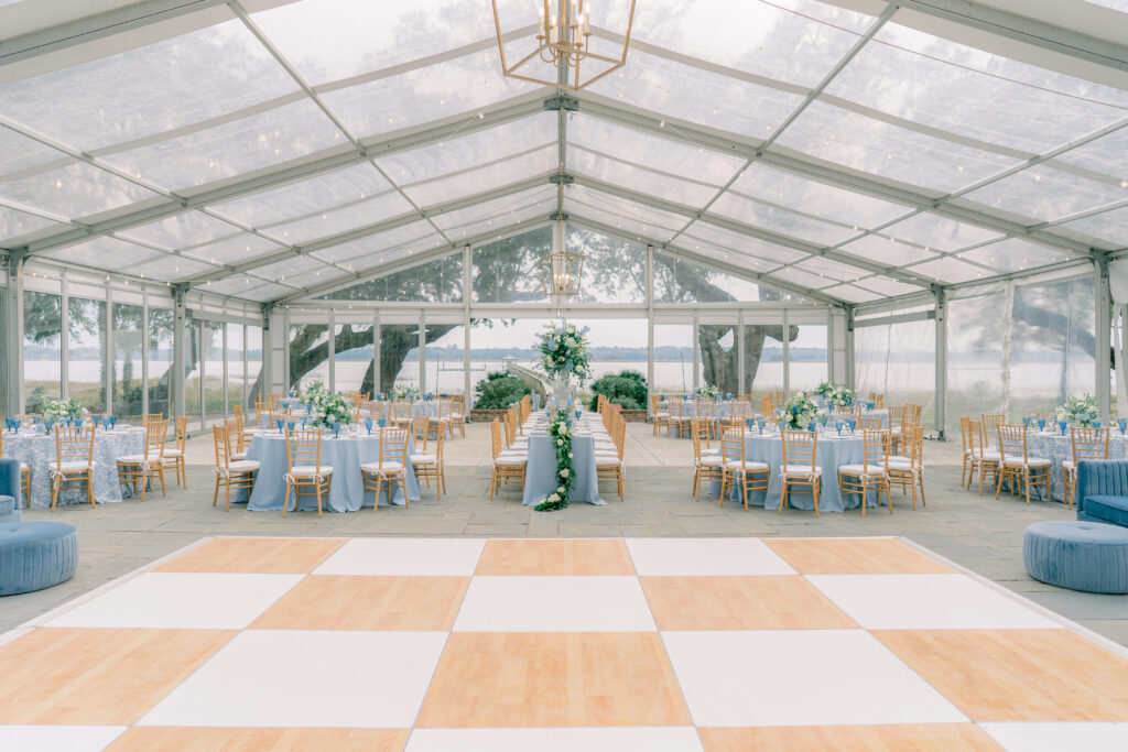 Blue and white wedding reception with tan accents and a clear tent. Lowndes Grove Charleston. 