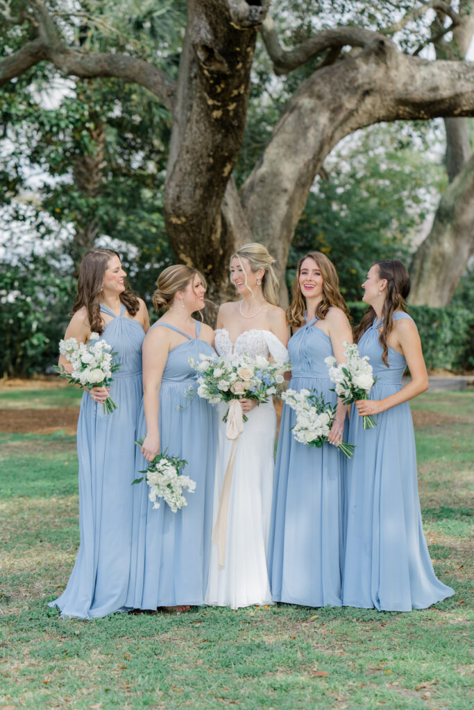 Bride and bridesmaids in blue dresses.