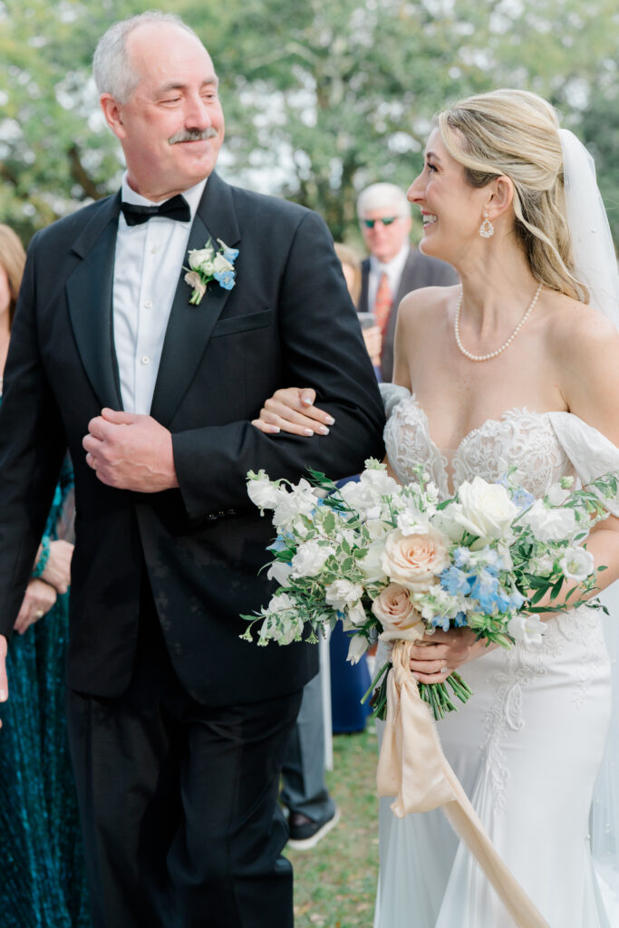 Bride looks at her dad during Charleston winter outdoor wedding ceremony. 