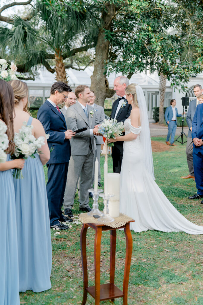 Groom shakes hand of father of the bride at Charleston wedding.