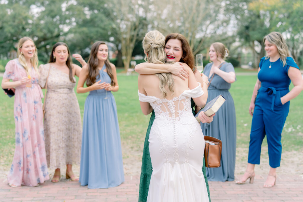 Bride hugging her friend after wedding ceremony in Charleston. 
