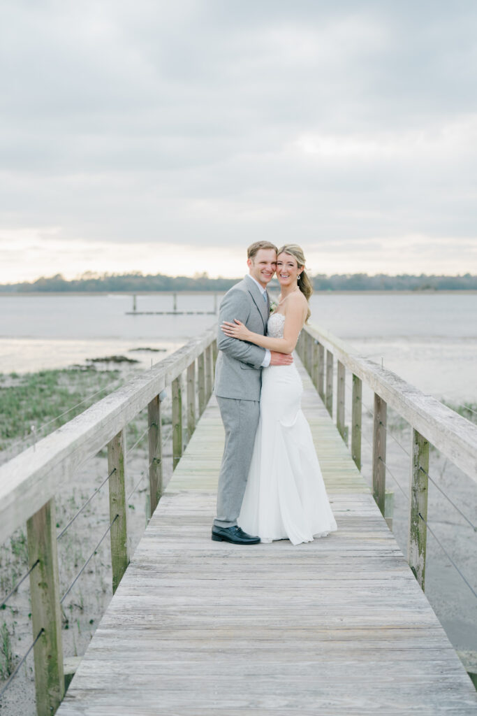 Sunset golden hour wedding portraits on the dock at Lowndes Grove.