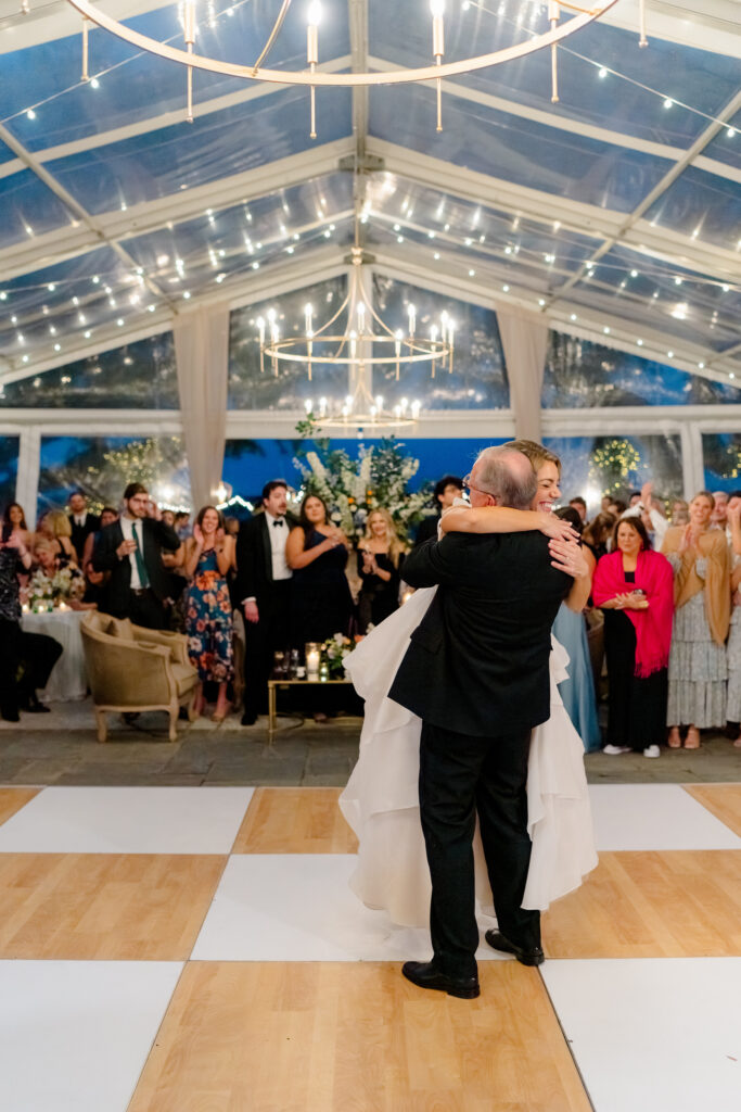 Father of the bride picks up daughter after first dance.