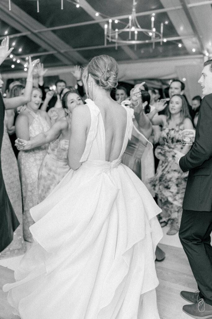 The party starts. Black and white photo of the dance floor opening during spring wedding in Charleston. 