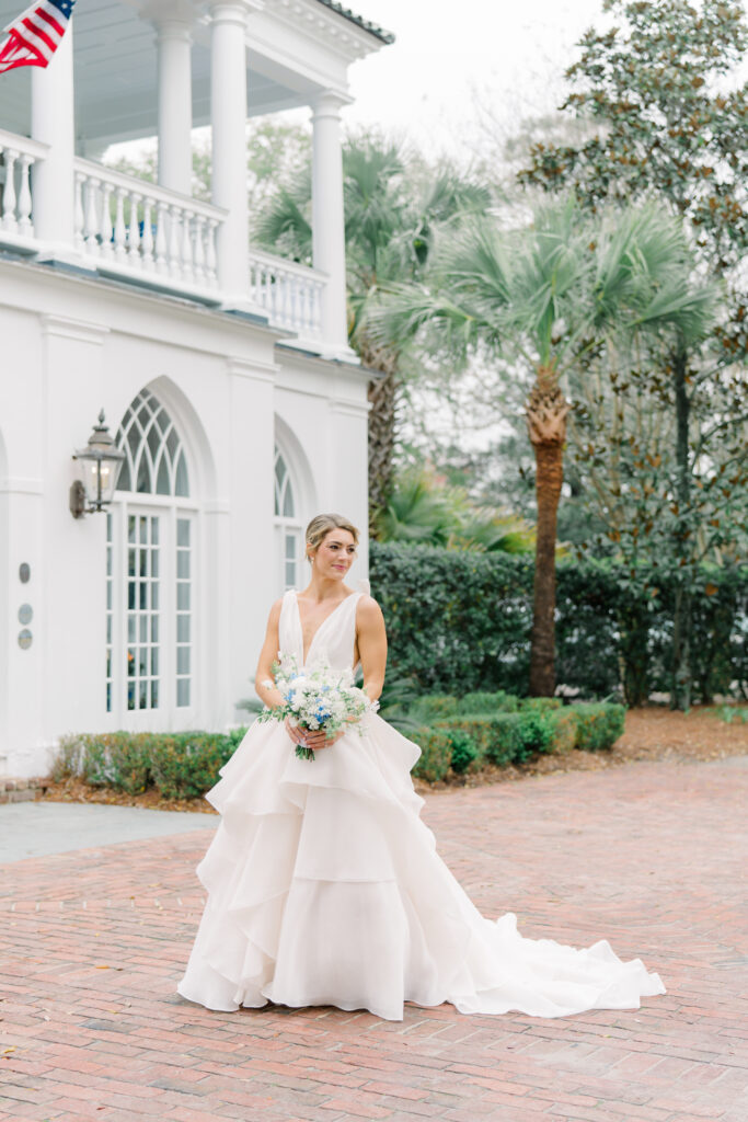Lowndes Grove bride portrait with palm tree and lantern. Flowing blush wedding dress.