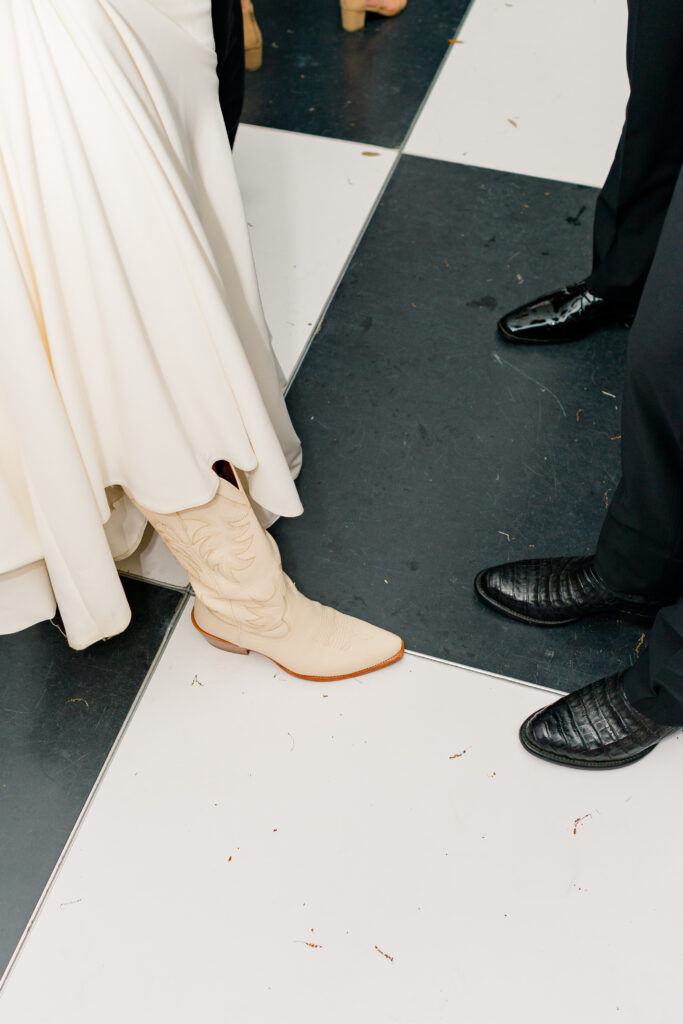 Bride and groom both wear cowboy boots at Charleston wedding.
