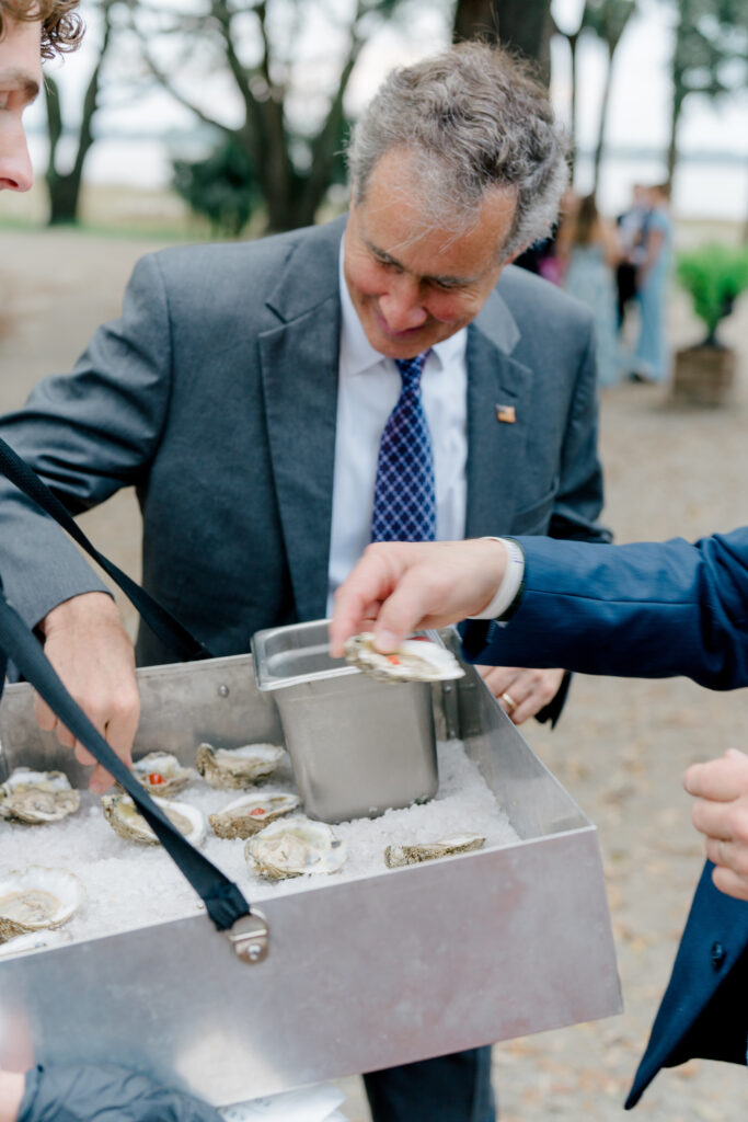 Wedding guests grab an oyster.