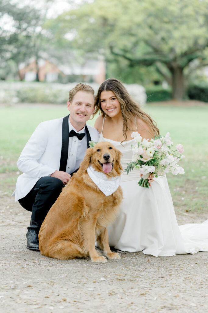 Bride and groom wedding day portrait with their dog. 
