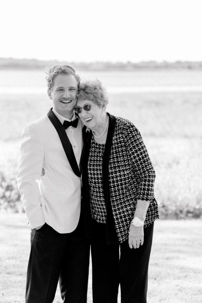 Groom with his grandmother on his wedding day. Black and white wedding photo.