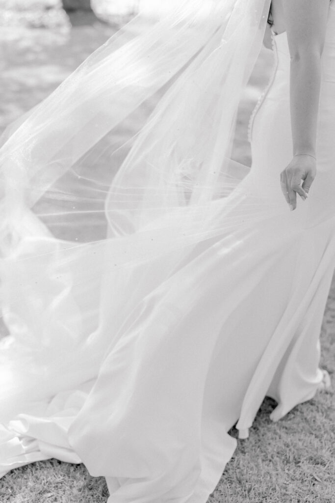 Black and white photo of veil blowing in the wind.