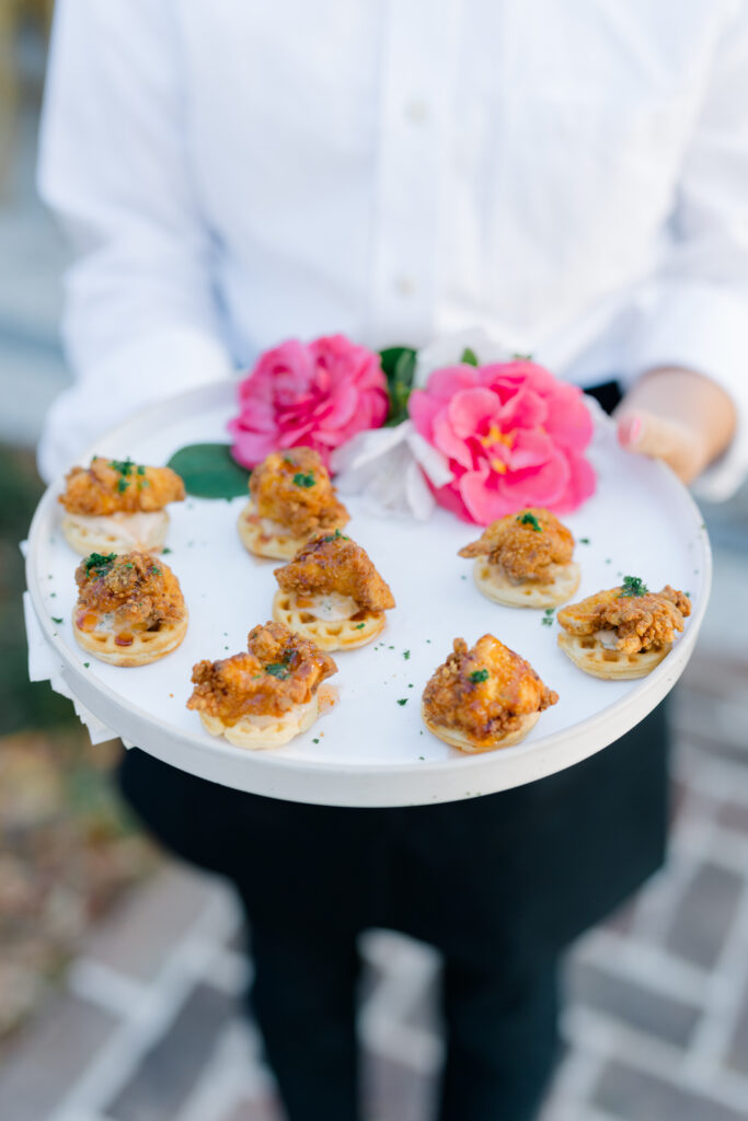 Mini chicken and waffles on a tray served at cocktail hour. Charleston wedding food. 