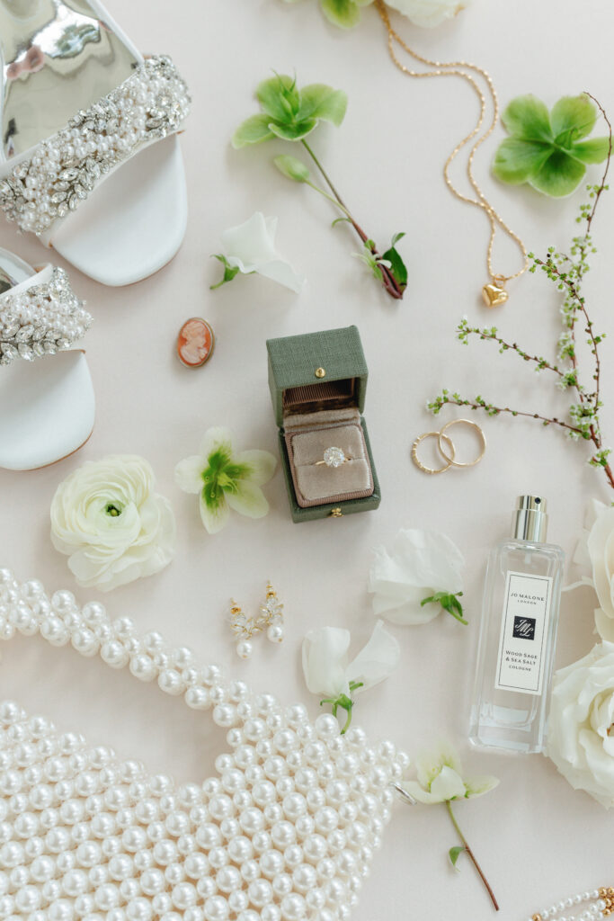 Bride's details. Perfume, heels, engagement ring, and fun pearl purse.