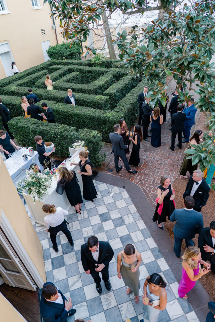 Wedding guests mingle in the maze at William Aiken House during cocktail hour. 