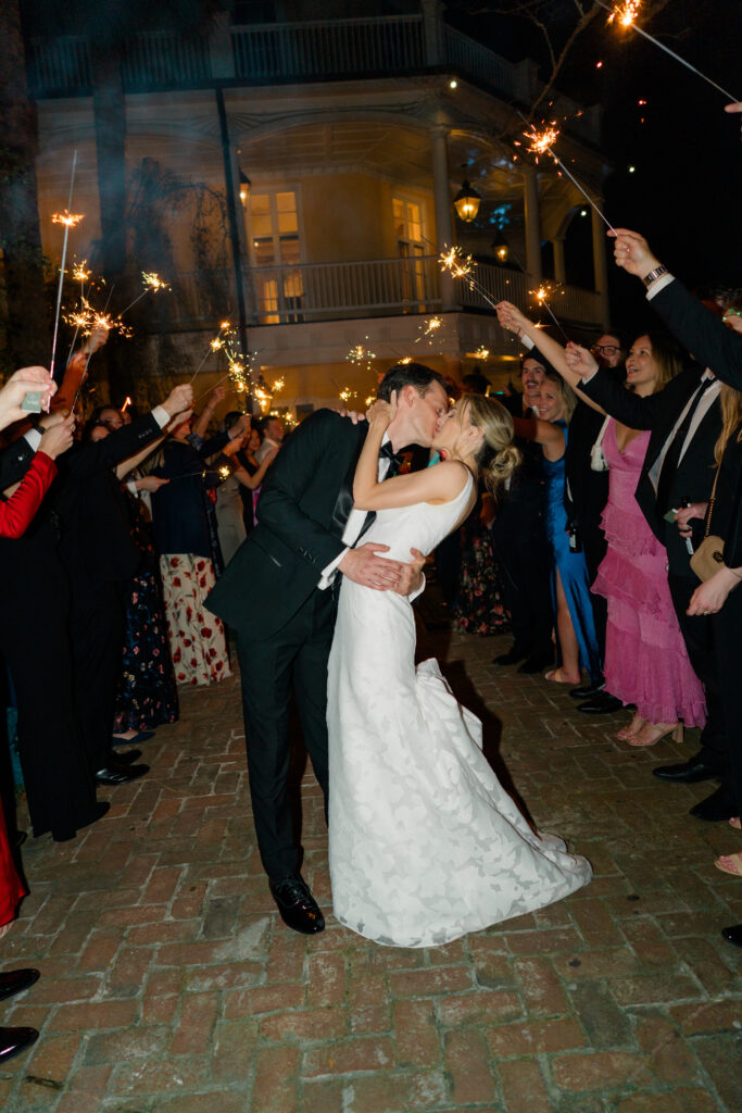 Sparkler exit dip kiss at Charleston spring wedding. 
