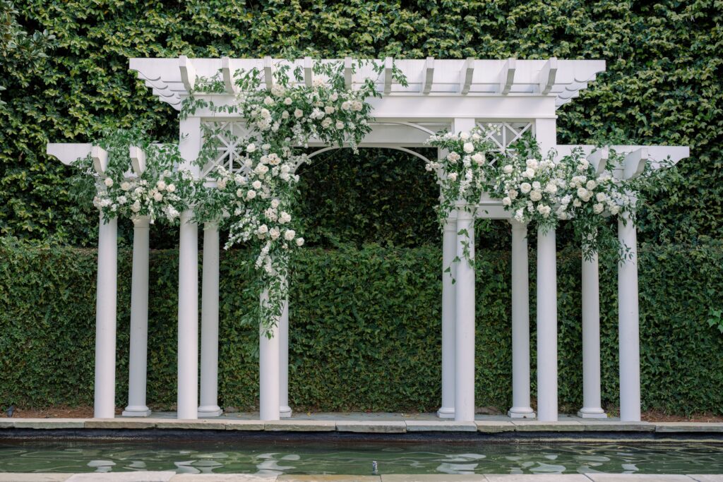 William Aiken House pergola covered in flowers for spring outdoor wedding ceremony. 