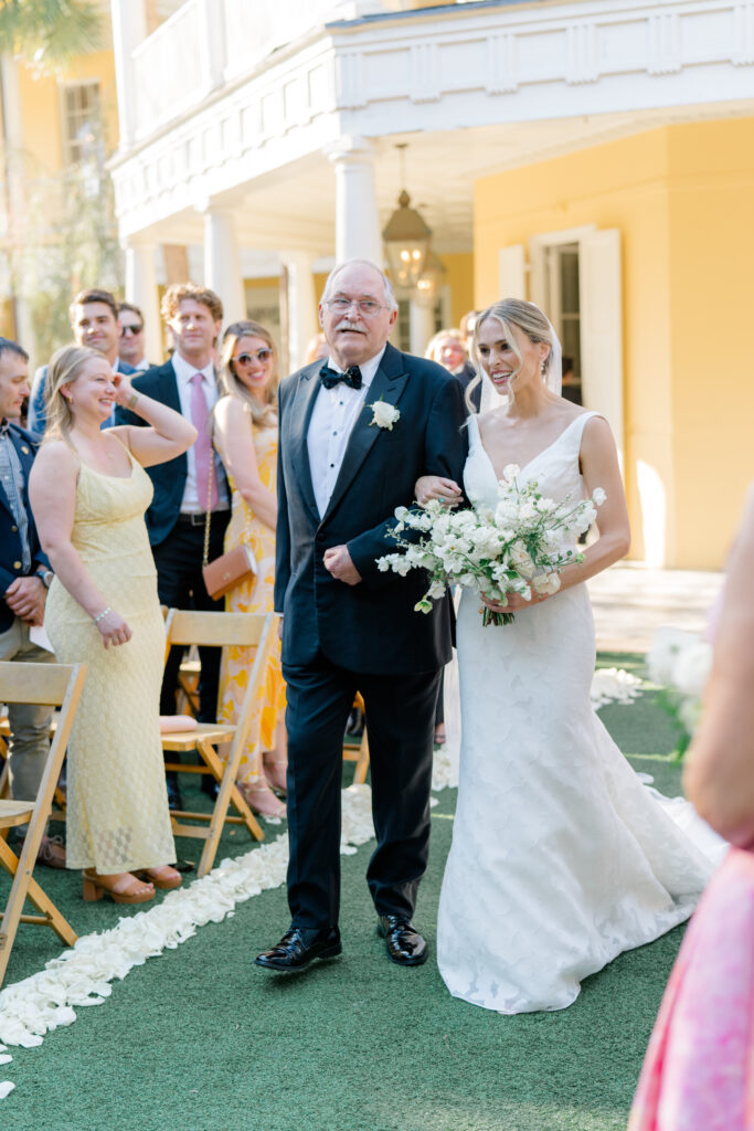 William Aiken House wedding ceremony. Bride walking up the aisle escorted by her grandfather. 