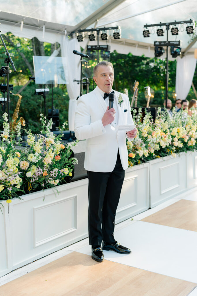 Father of the bride speech. Father of the bride wearing white tuxedo jacket. 