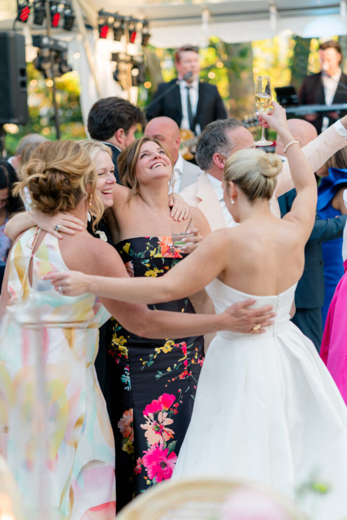 Mother of the bride hits the dance floor during outdoor wedding reception. 