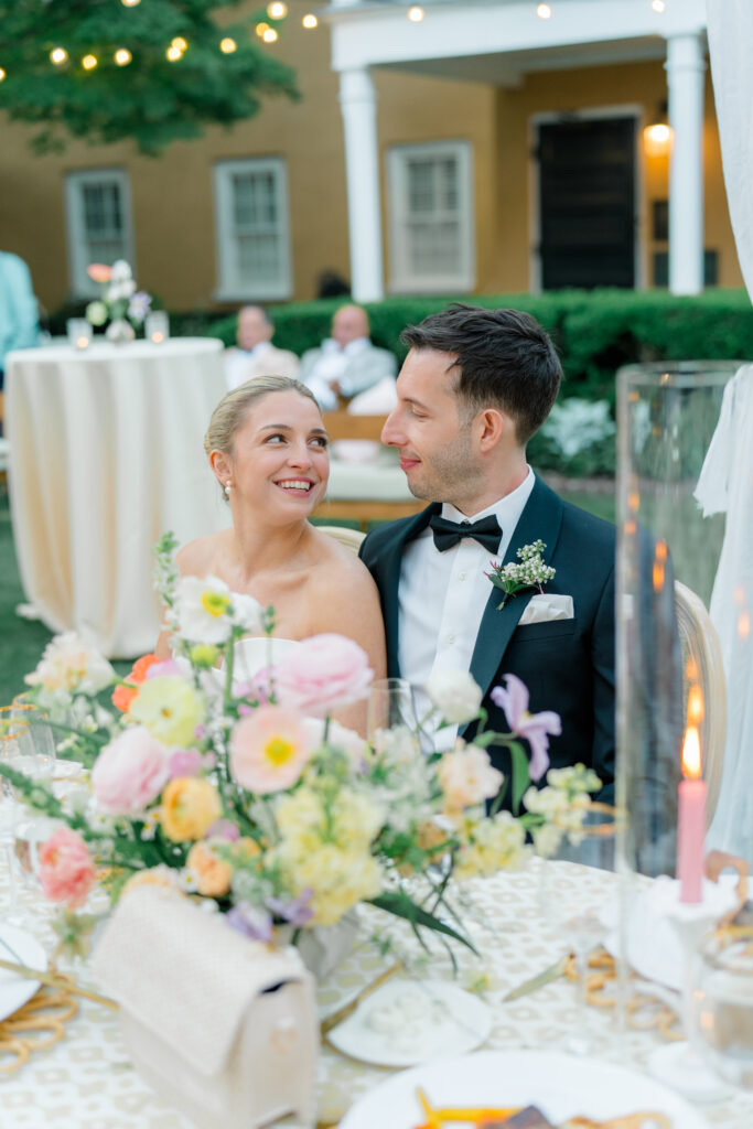 Bride and groom at the head table. Gorgeous outdoor spring wedding reception in downtown Charleston. 