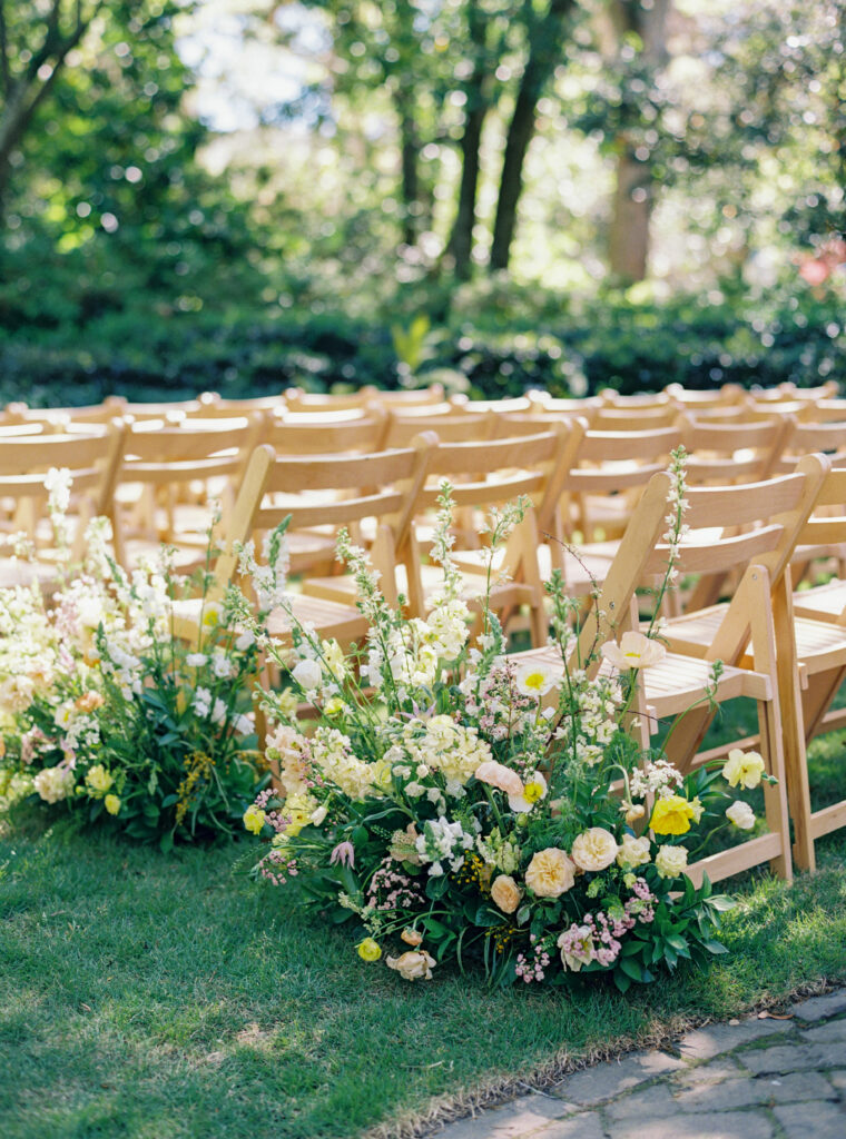 Lush statement aisle flowers at spring wedding in Charleston. 