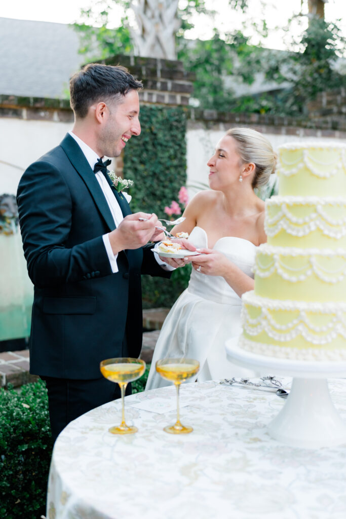 Bride and groom feed each other cake. 