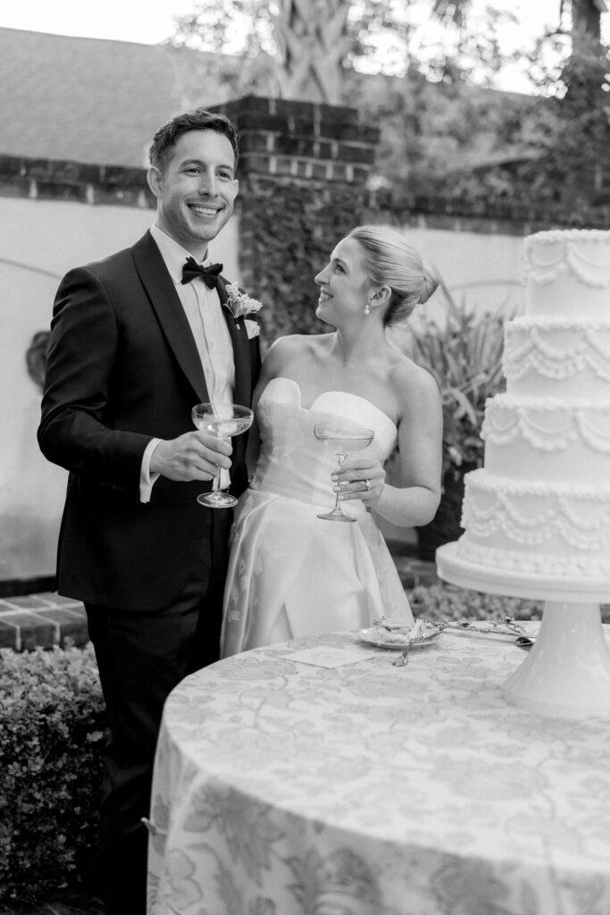 Bride and groom champagne toast after cutting the cake. Pure Luxe Bride wedding. 