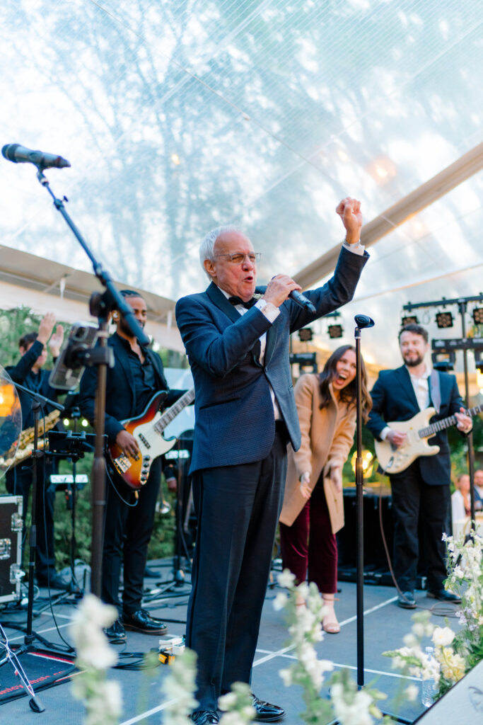 Father of the groom brings the house down during live performance of "New York, New York". Charleston destination wedding. 