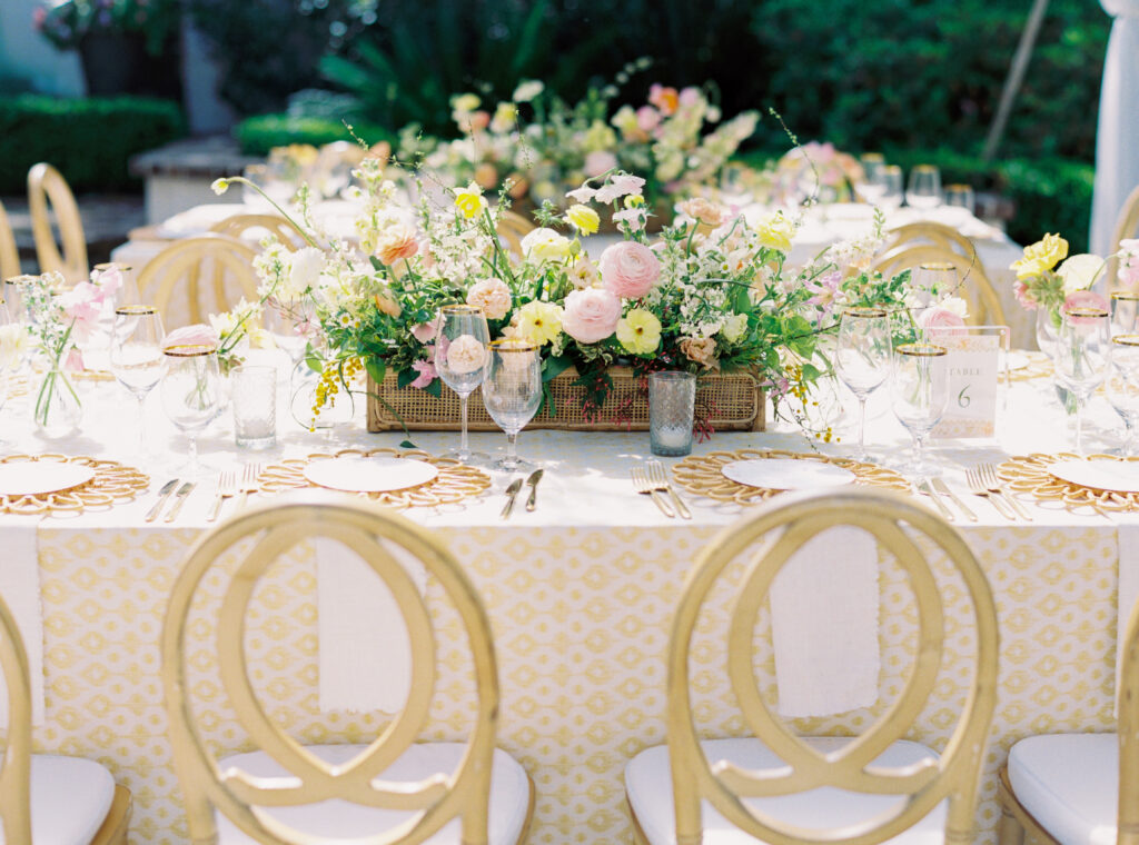 Pink and yellow wedding reception table set up. Film photographer in Charleston. 