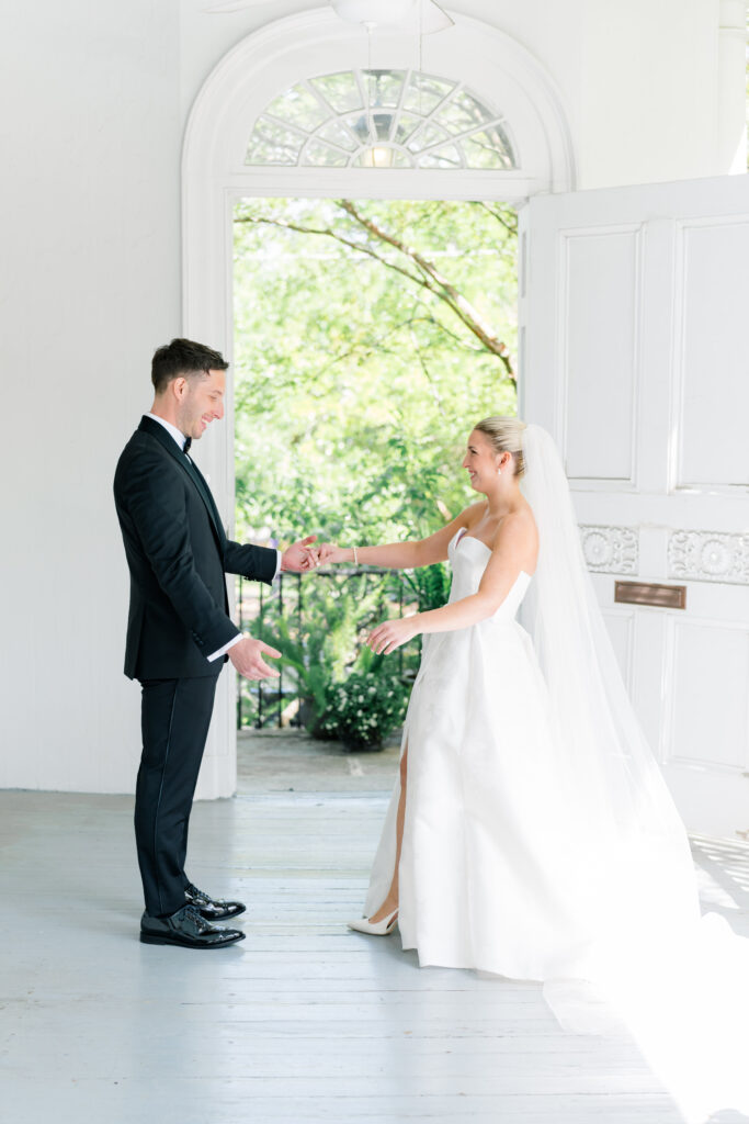 Happy bride and groom see each other for the first time during spring destination wedding in Charleston. 