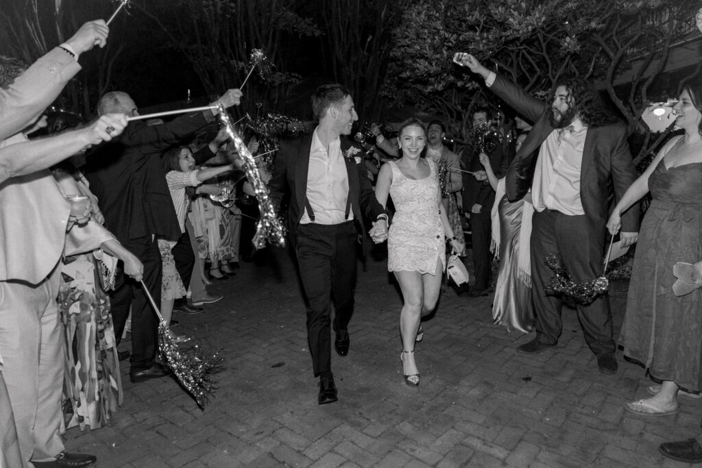 Bride and groom wedding exit. Black and white wedding photo. 