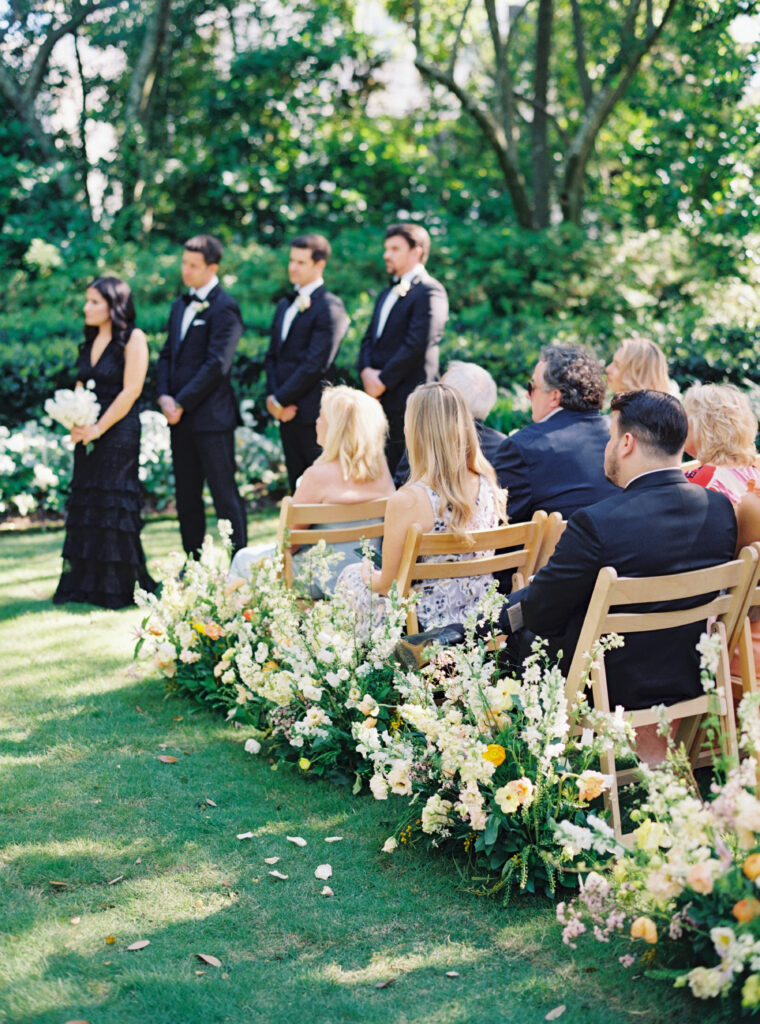 Film photo of wedding guests sitting during the ceremony. 